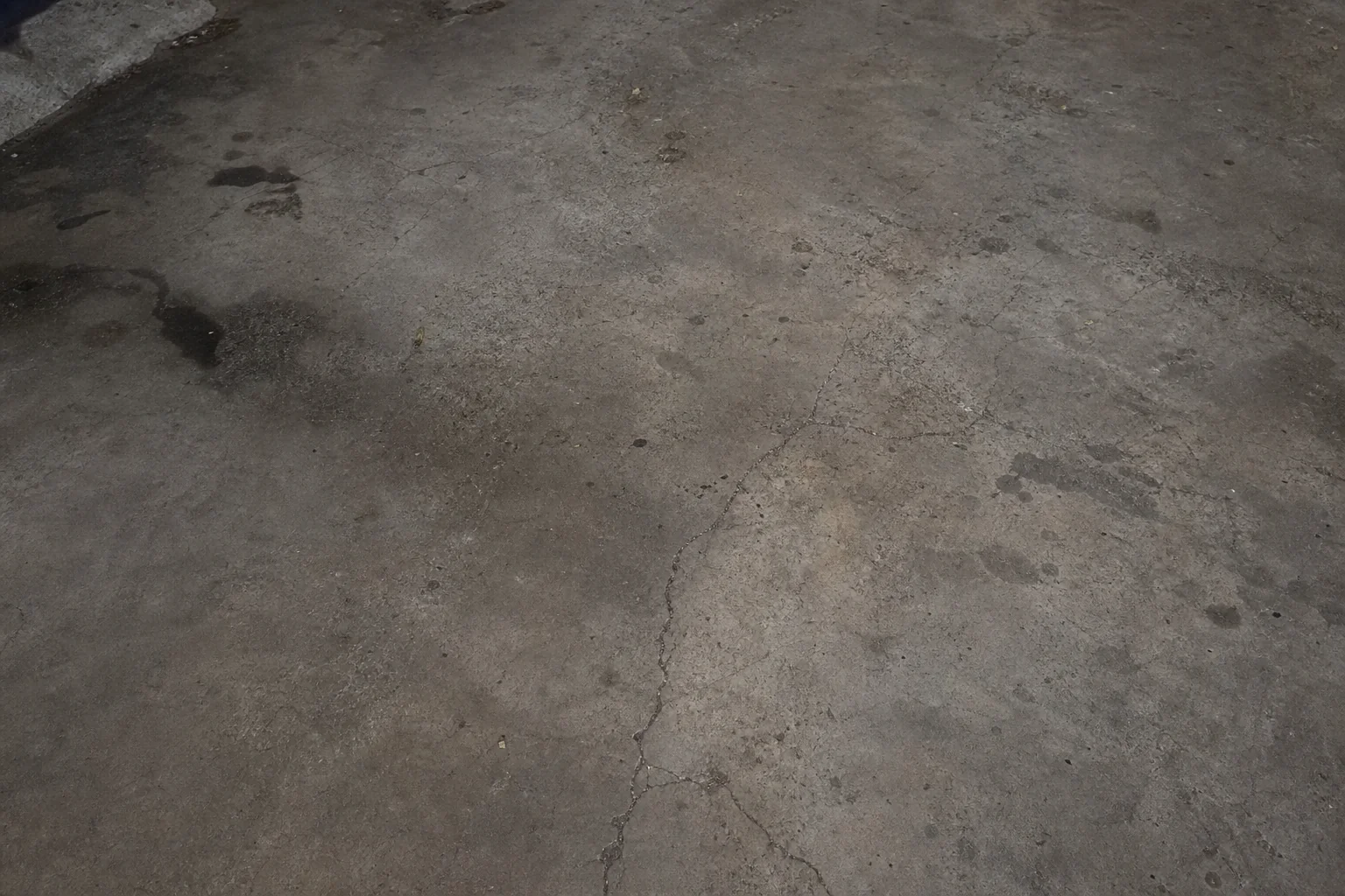 Cracked stained concrete before